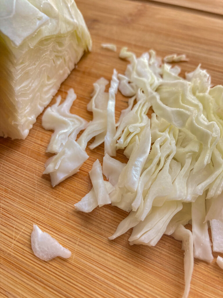 shredded cabbage sitting on a cutting board